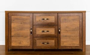Wooden sideboard cabinet with two doors and three drawers, featuring metal handles, against a white wall.