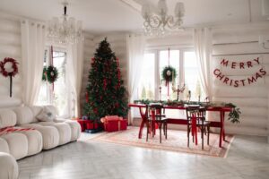 A festive room with a decorated Christmas tree, presents, and a dining table set for Christmas dinner under a "Merry Christmas" banner.